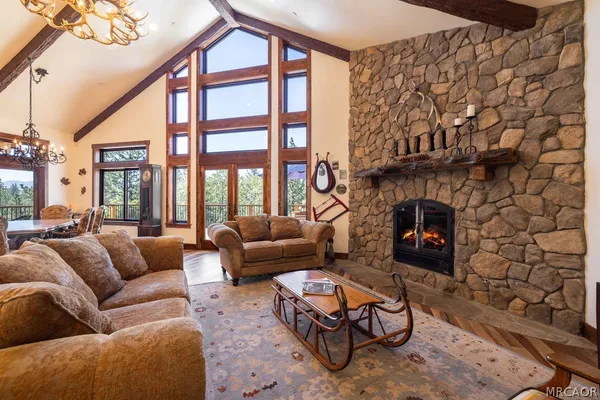 a living room with furniture a fireplace and a large window