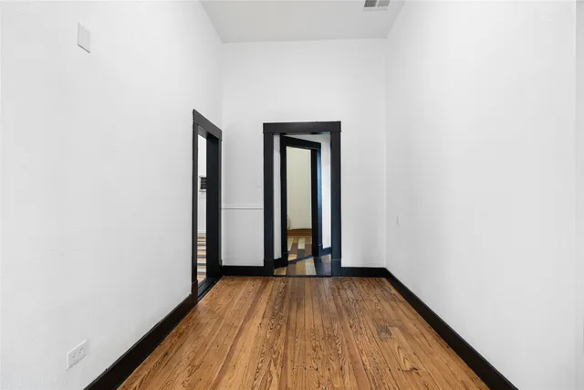 a view of a room with wooden floor