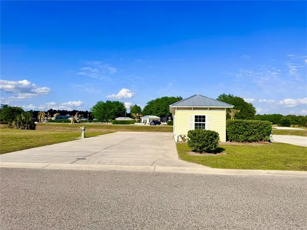 a view of house with yard and road