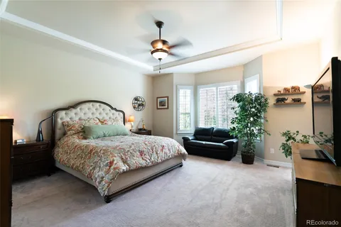 a bedroom with a bed couch and a window