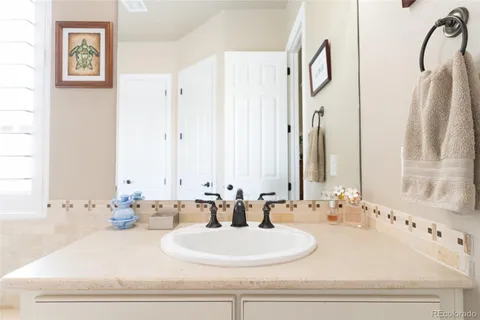 a bathroom with double vanity sinks a mirror and a shower