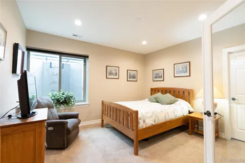 a bedroom with a bed and a potted plant