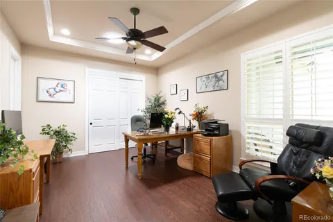 a view of a workspace with furniture and a window