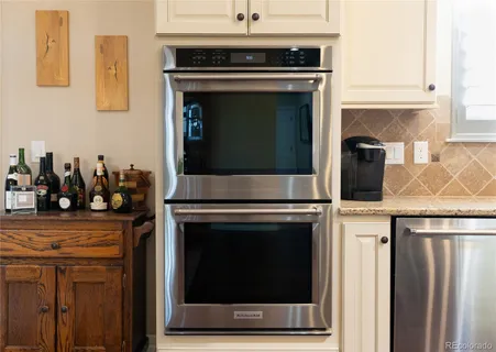 a stove top oven sitting inside of a kitchen