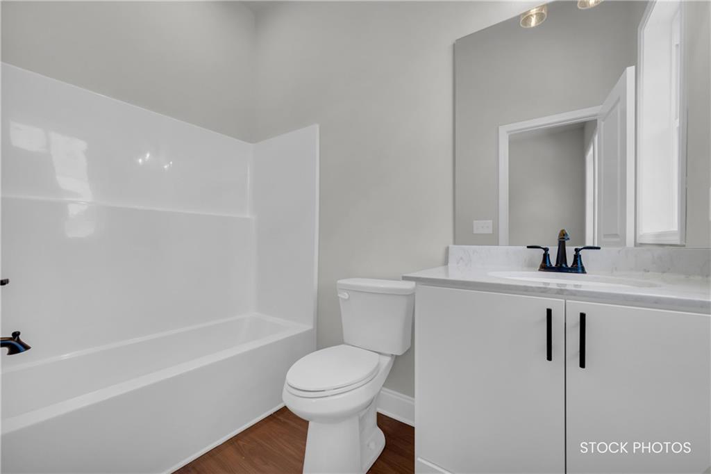 1038 Homestead Way Street Dacula, GA 30019 - Photo 18 of 36 a bathroom with a sink a toilet and shower