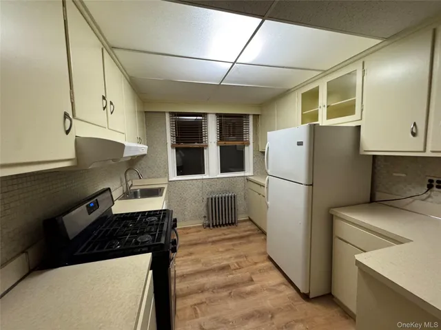 a kitchen with a refrigerator and a stove