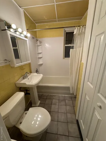 an empty room with closet and windows