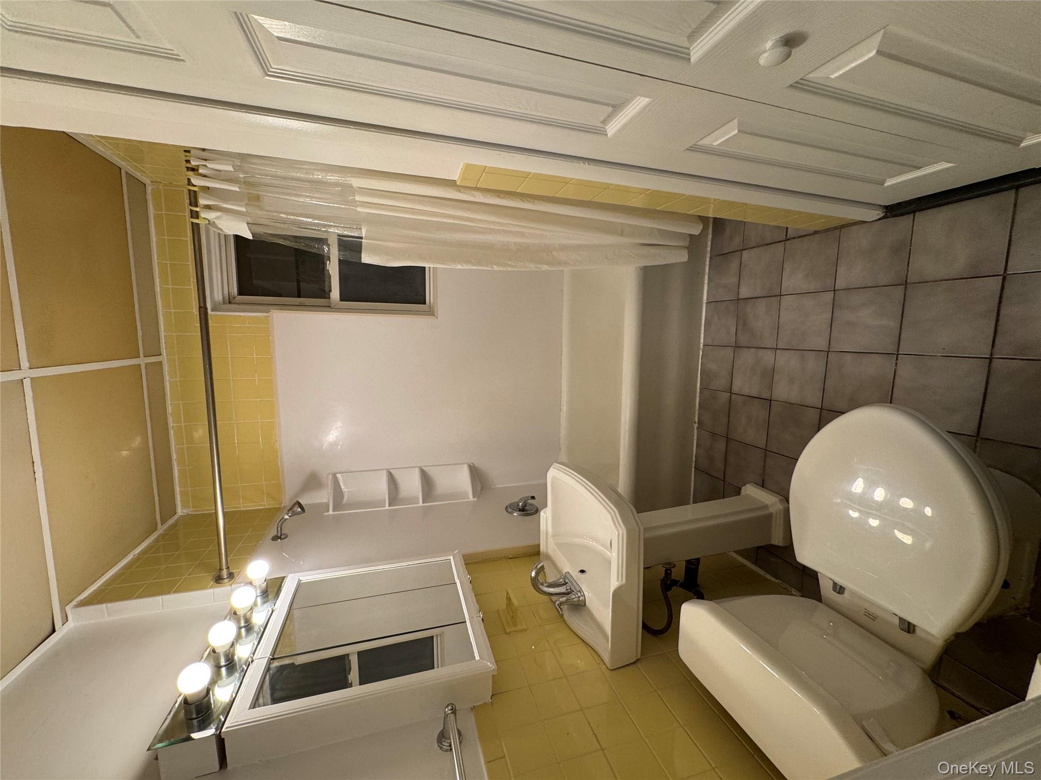 40-13 201st Street Queens, NY 11361 - Photo 8 of 16 a bathroom with a sink toilet and shower