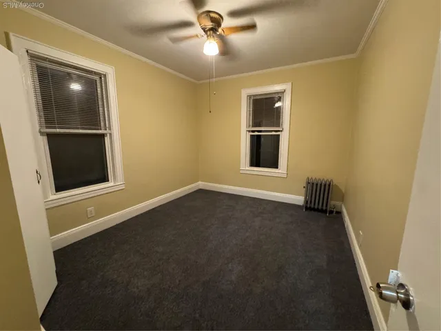 an empty room with a empty space and a ceiling fan