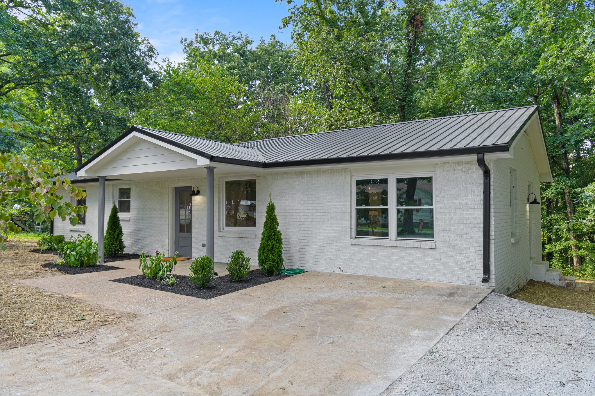 6167 Parker Road Lyles, TN 37098 - Photo 1 of 28 a front view of a house with a garden