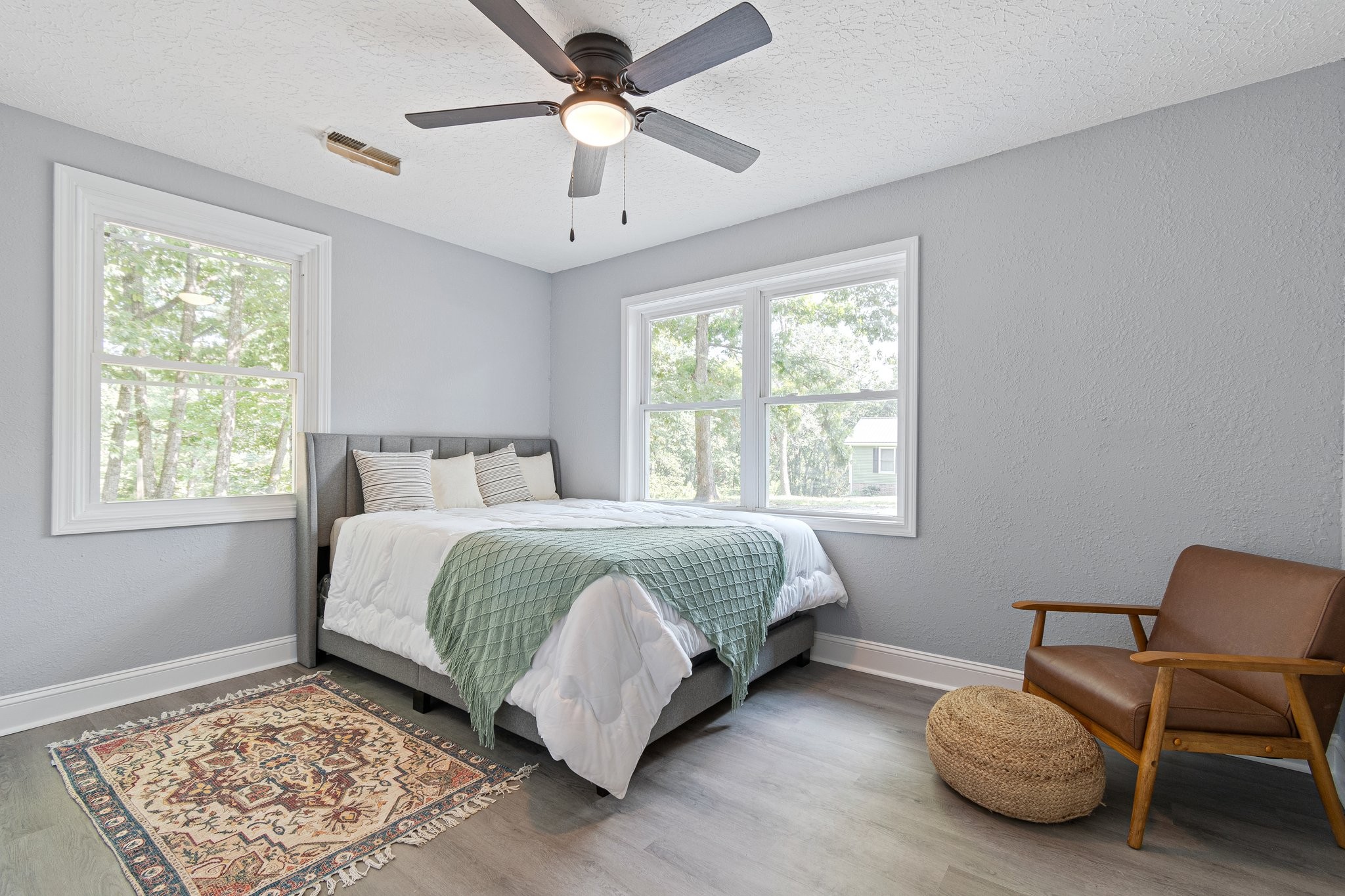 6167 Parker Road Lyles, TN 37098 - Photo 25 of 28 a spacious bedroom with a bed a chair and a window