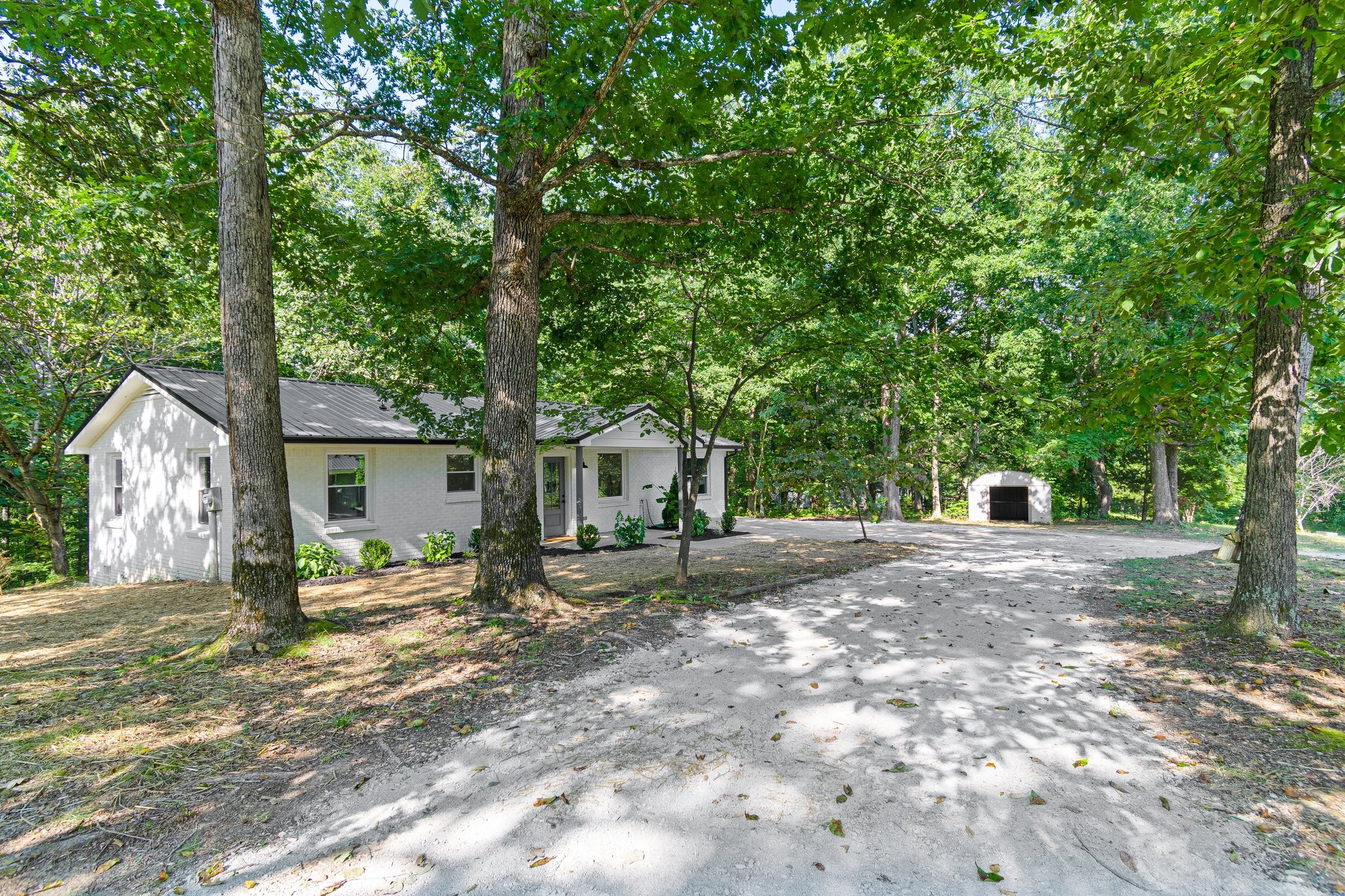 6167 Parker Road Lyles, TN 37098 - Photo 6 of 28 a house with trees in the background