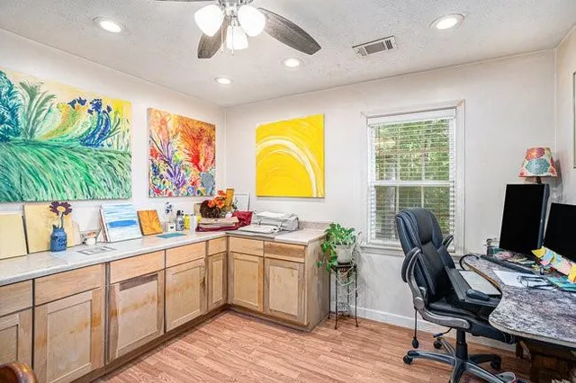 a kitchen with a sink appliances cabinets and dining area