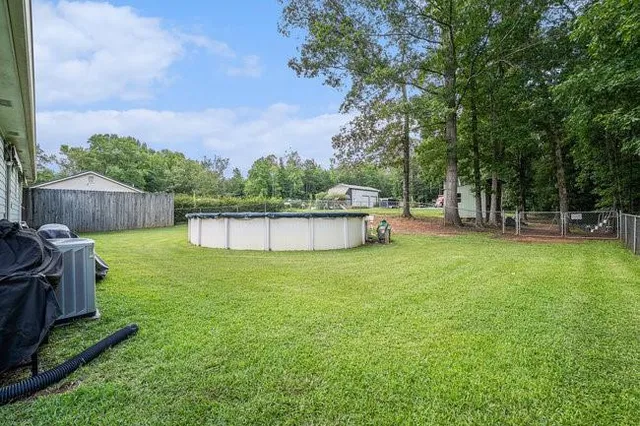 a view of a backyard with a garden and fire pit
