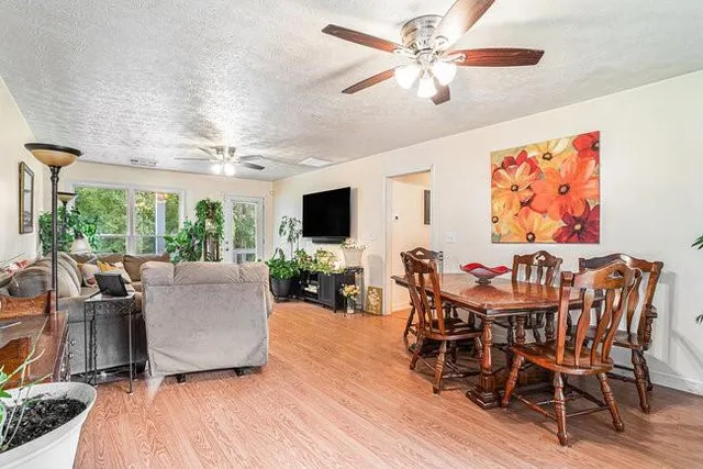 a view of a dining room with furniture window and wooden floor