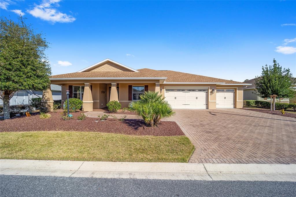 8971 Southwest 89th Loop Ocala, FL 34481 - Photo 1 of 1 a front view of a house with garden
