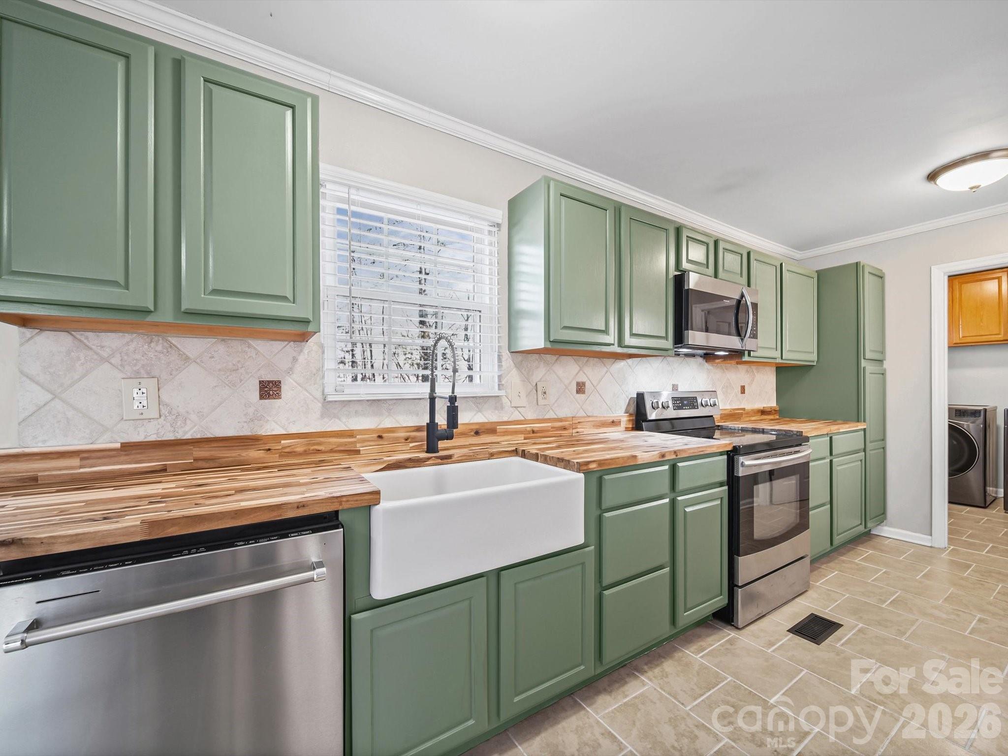 10351 Fink Road Mount Pleasant, NC 28124 - Photo 11 of 20 a kitchen with stainless steel appliances granite countertop a sink stove and cabinets