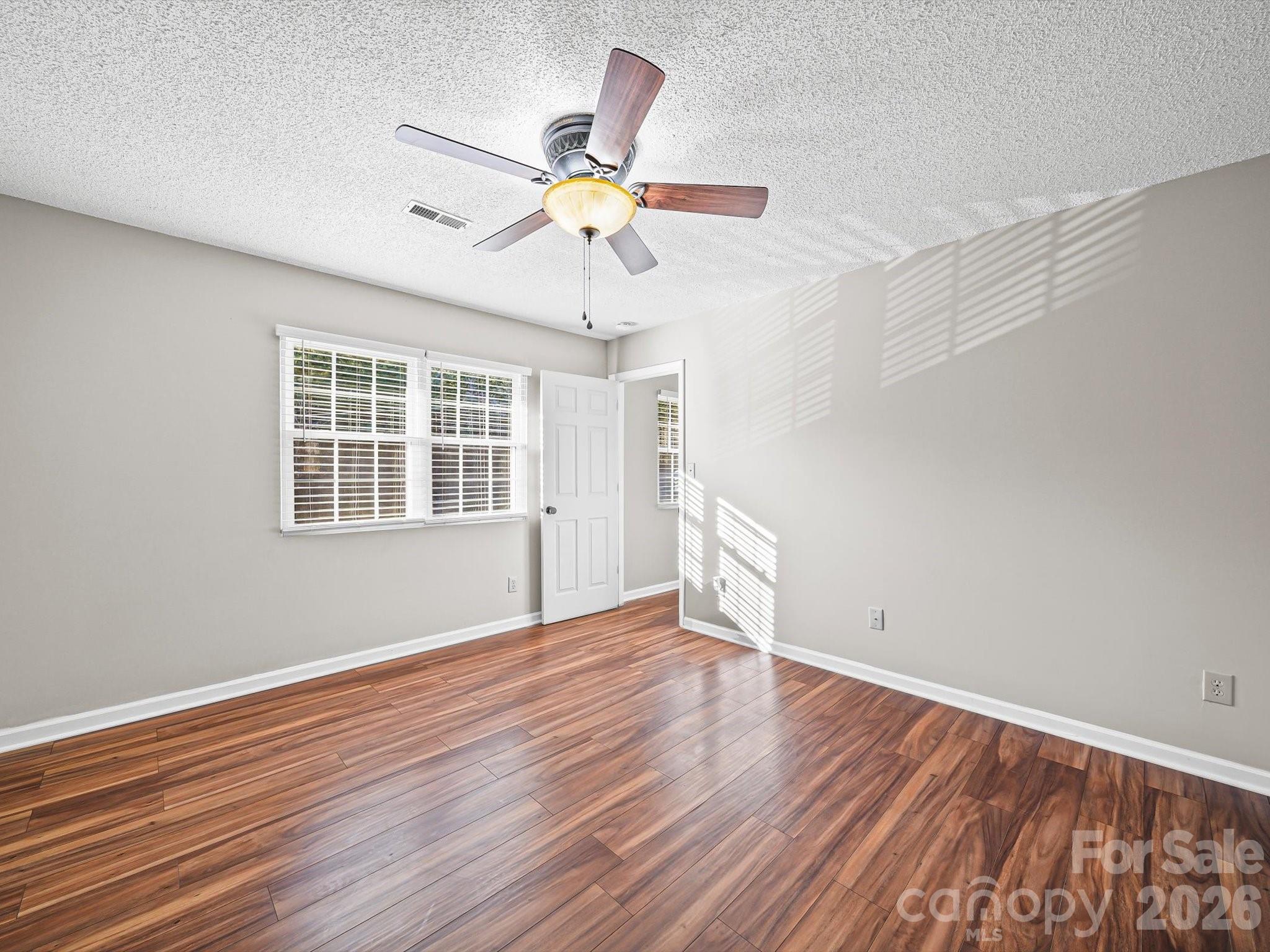 10351 Fink Road Mount Pleasant, NC 28124 - Photo 17 of 20 a view of an empty room with wooden floor and a window