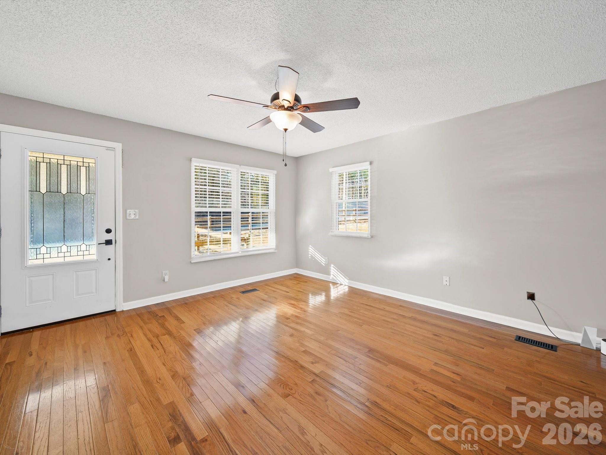 10351 Fink Road Mount Pleasant, NC 28124 - Photo 4 of 20 a view of an empty room with wooden floor and a window