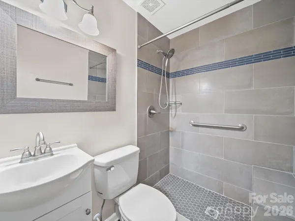 a white toilet sitting next to a bathroom sink