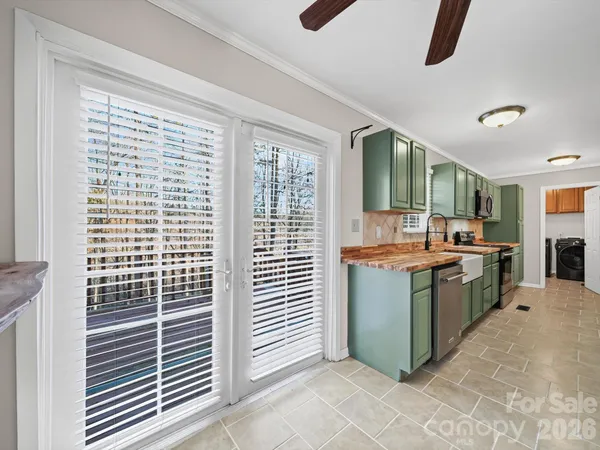 a room with kitchen island granite countertop furniture and a window