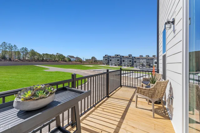 a view of a balcony with wooden floor and fence