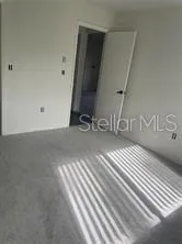 a view of a closet with wooden floor