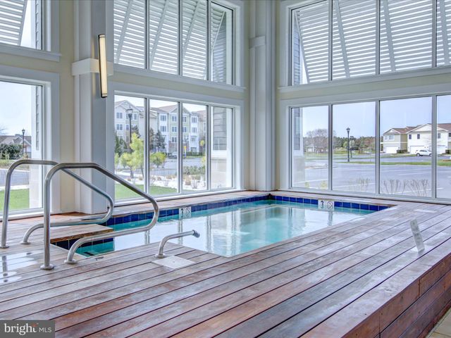 a view of a swimming pool with outdoor seating