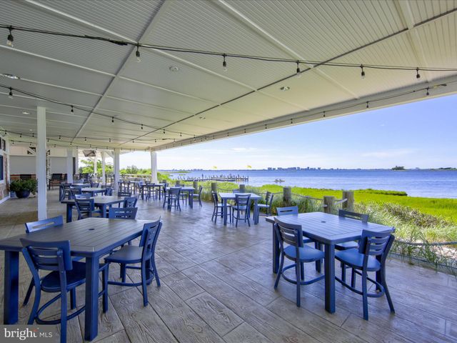 a patio with glass top table and chairs