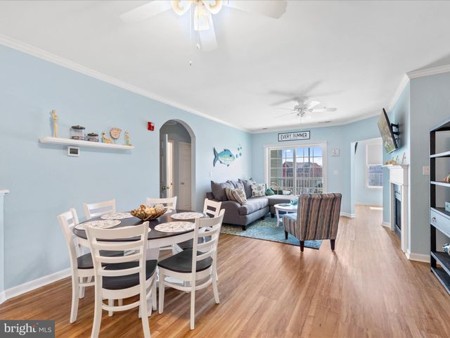 a view of a dining room with furniture wooden floor and chandelier