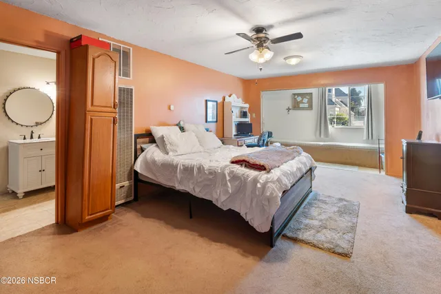 a bedroom with a bed dresser and a window