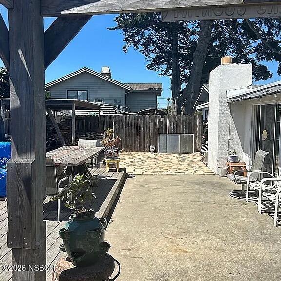 766 South 6th Street Grover Beach, CA 93433 - Photo 18 of 20 a view of a patio with table and chairs and potted plants
