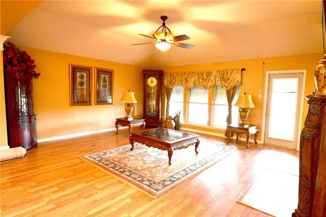 a living room with fireplace furniture and a large window