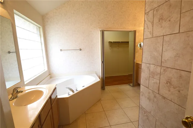 a bathroom with a tub and a sink