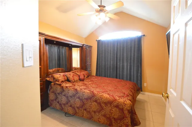 a bed sitting in a bedroom next to a bathroom