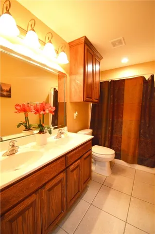 a bathroom with a sink mirror vanity and toilet
