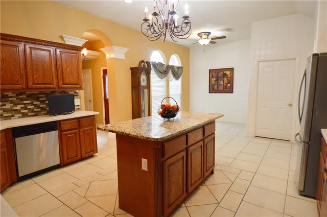 a kitchen with stainless steel appliances granite countertop a refrigerator a oven a sink and dishwasher