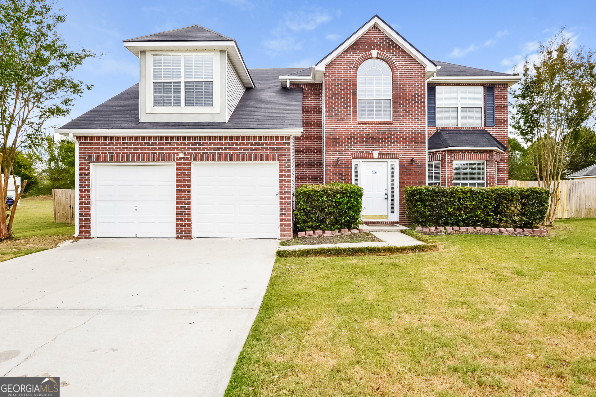 1707 Deer Crossing Way Jonesboro, GA 30236 - Photo 1 of 17 a front view of a house with a yard and garage