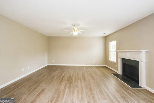 wooden floor in an empty room with a fireplace