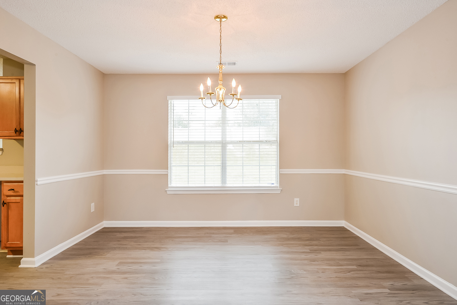 1707 Deer Crossing Way Jonesboro, GA 30236 - Photo 4 of 17 an empty room with wooden floor and windows