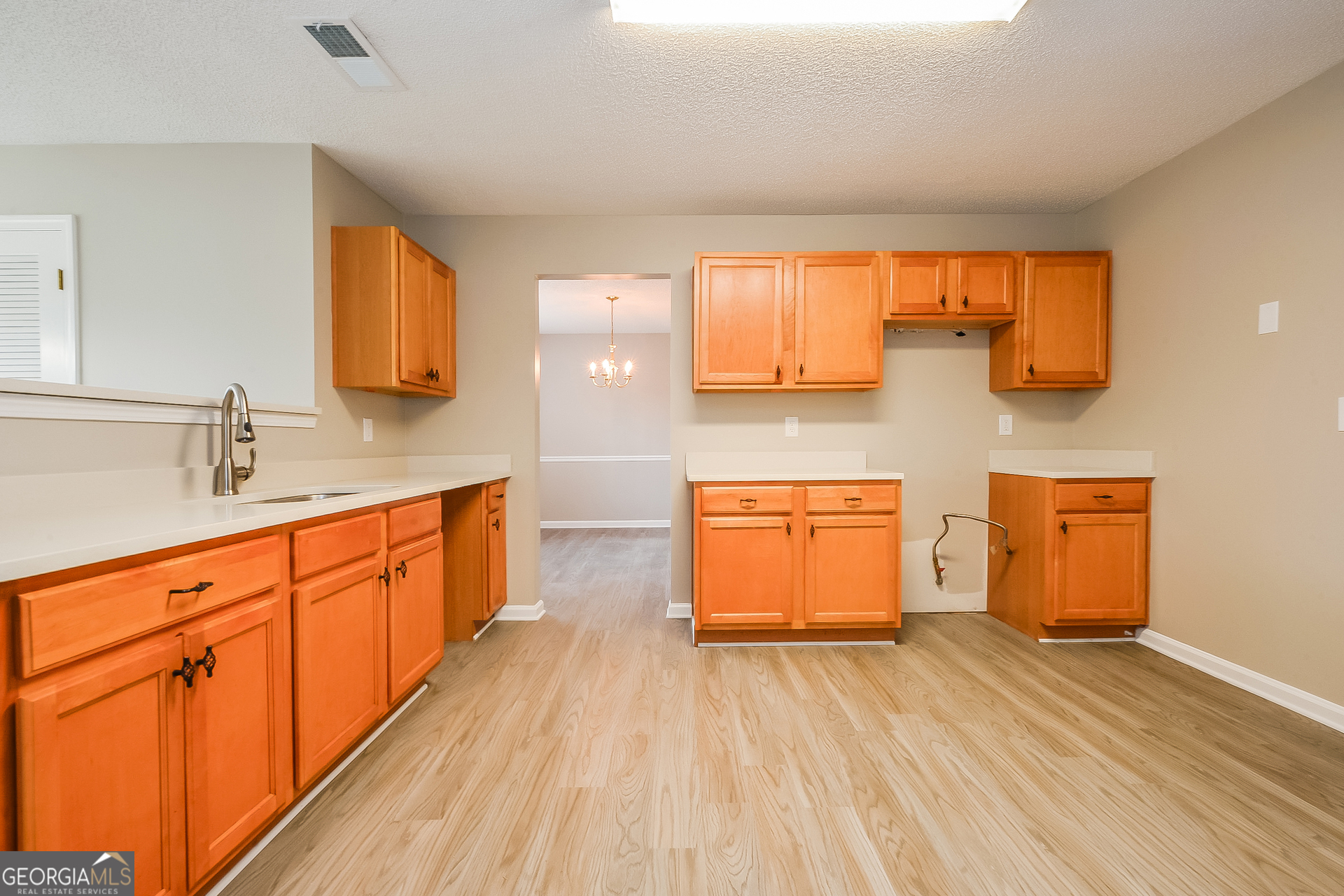 1707 Deer Crossing Way Jonesboro, GA 30236 - Photo 5 of 17 a kitchen with stainless steel appliances granite countertop a sink and cabinets with wooden floor