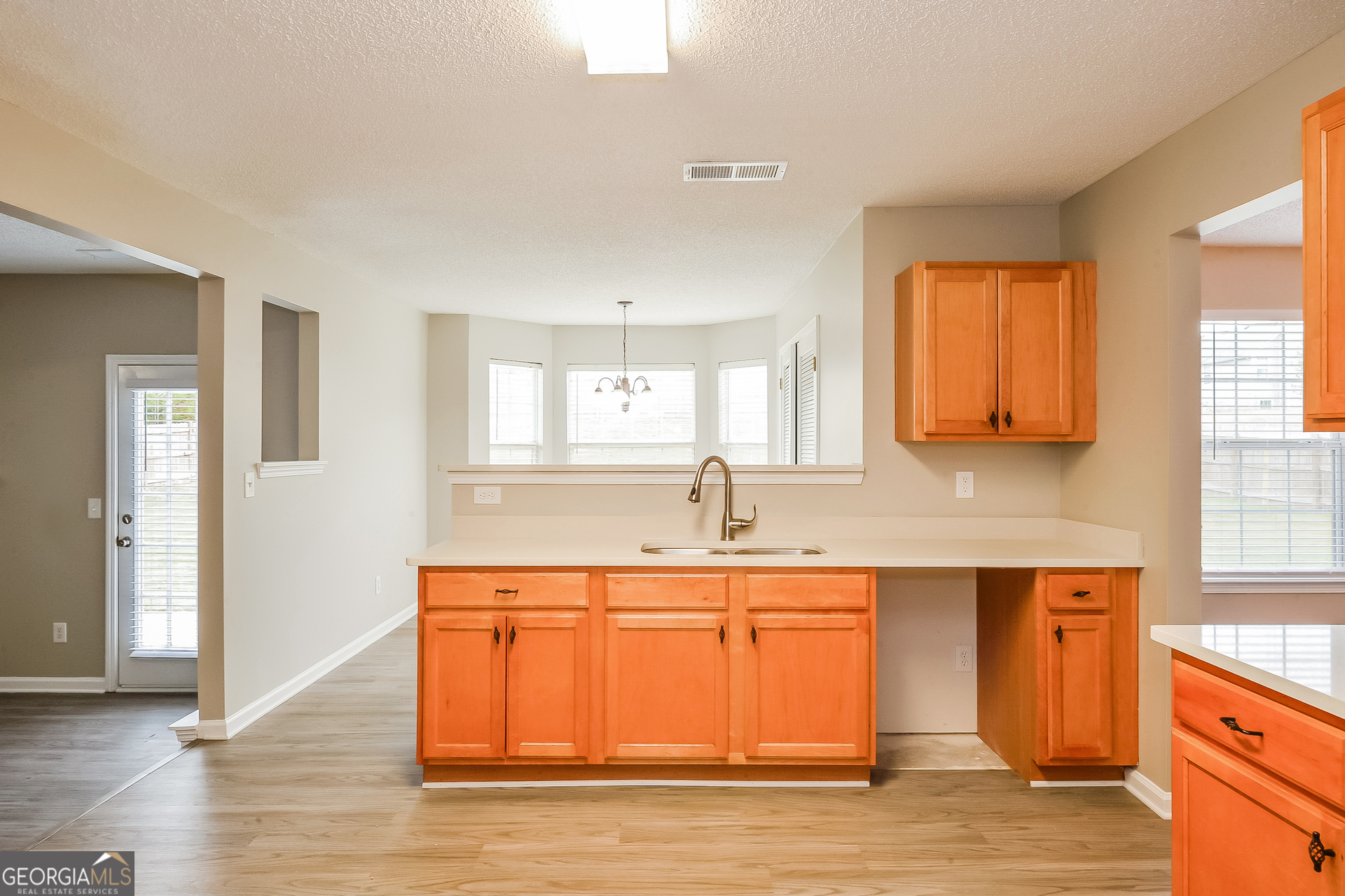 1707 Deer Crossing Way Jonesboro, GA 30236 - Photo 6 of 17 a kitchen with a sink cabinets and wooden floor