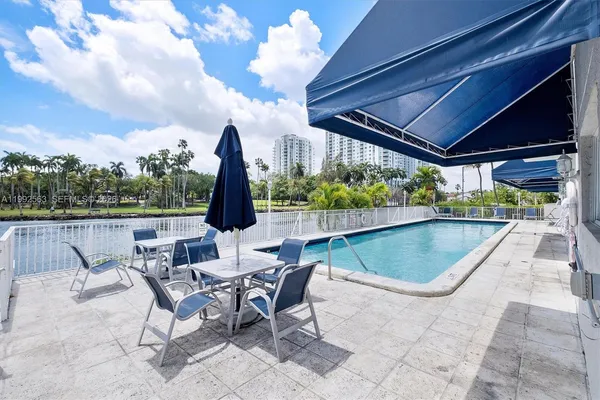 a view of swimming pool with outdoor seating and plants