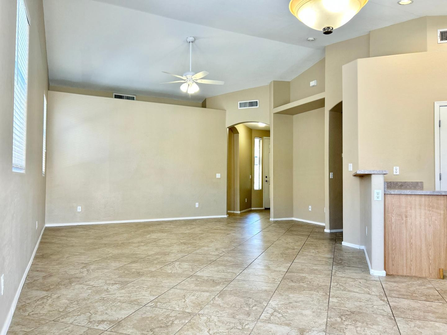 6660 East Roland Street Mesa, AZ 85215 - Photo 6 of 17 a view of an empty room with wooden floor and a bathroom