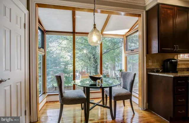 a dining room with furniture window and wooden floor