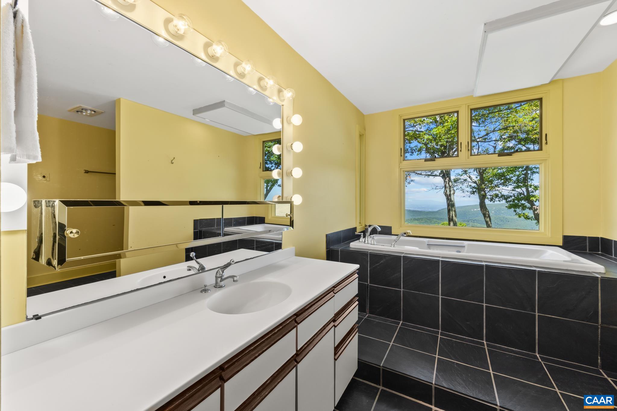 7098 Bucks Elbow Mountain Road Crozet, VA 22932 - Photo 28 of 57 a bathroom with a sink and a mirror