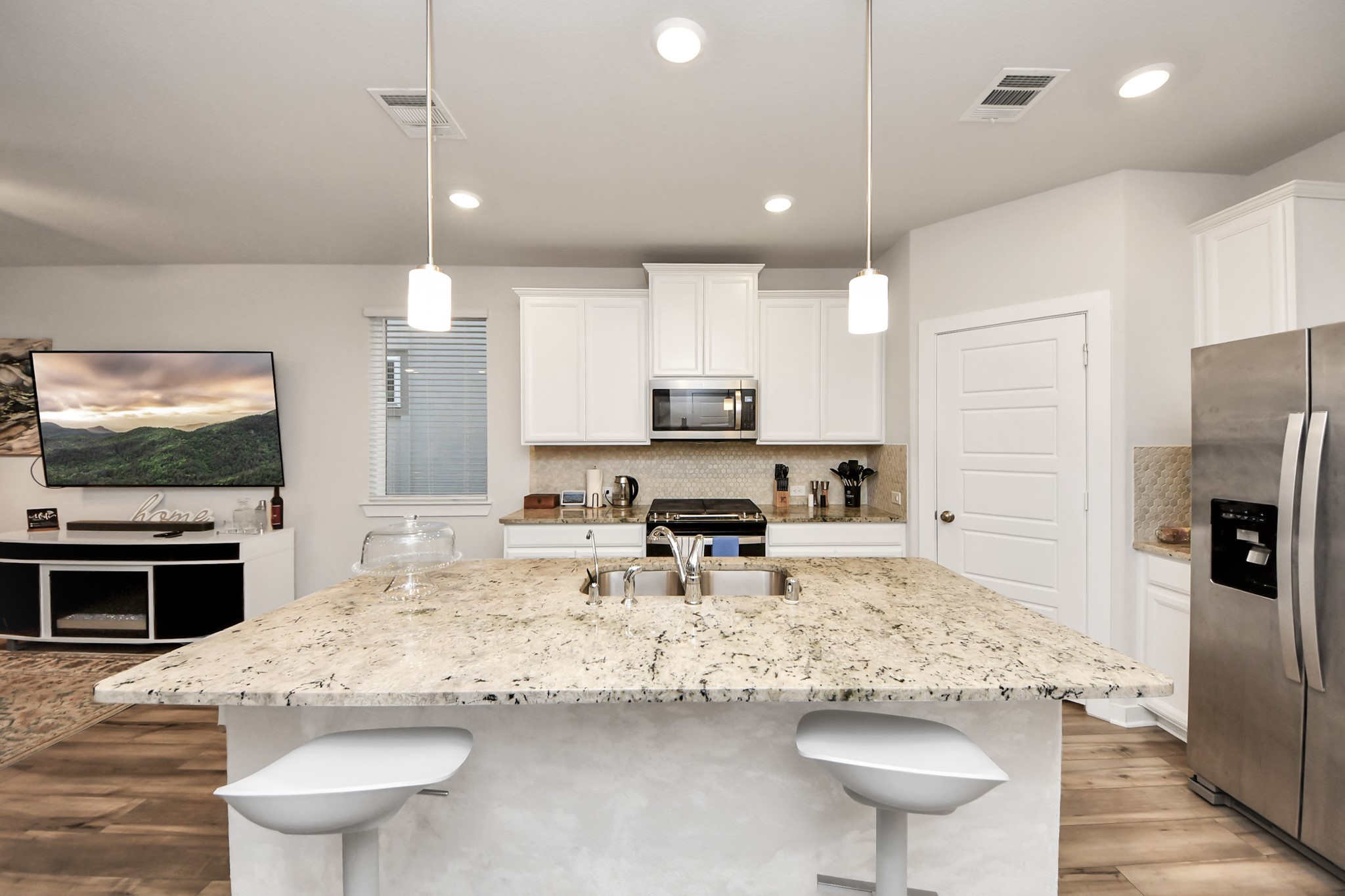 8207 Rising Stream Drive Houston, TX 77063 - Photo 20 of 50 a kitchen with stainless steel appliances kitchen island granite countertop a sink refrigerator and cabinets