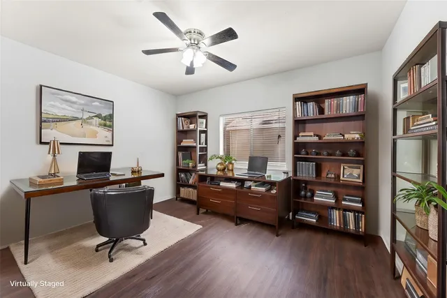 a view of a workspace with furniture and a window