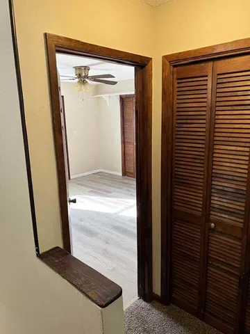 a view of a hallway with wooden floor