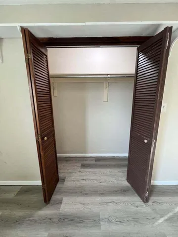 an entryway with wooden floor and door